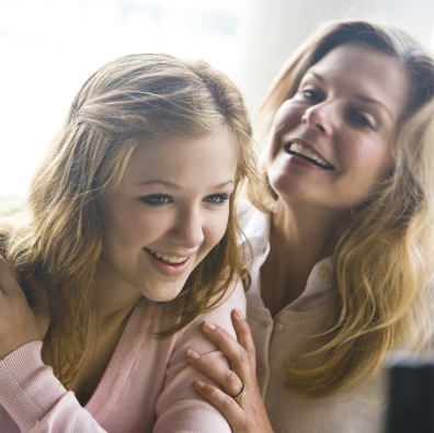 Mother and teen daughter smiling after wisdom tooth removal