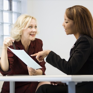Dental team member explaining payment plan to dentistry patient