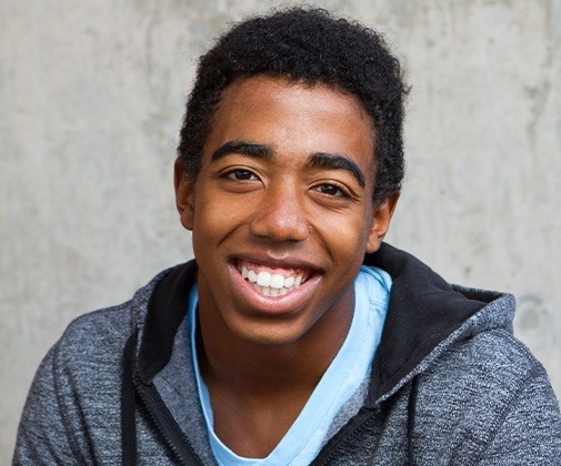 Young man smiling after wisdom tooth extraction