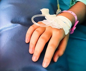 Patient with I V sedation needle in hand