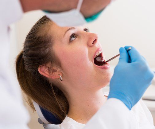 Dentist checking patient's smile after wisdom tooth extraction and P R F thearpy