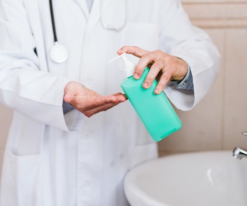 Dentist washing and sanitizing hands