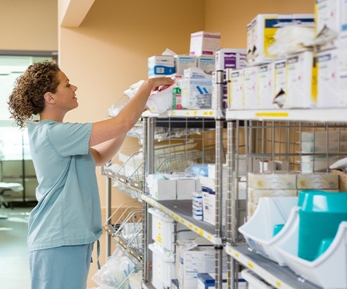 Dental team member organizing sterilized disposable materials