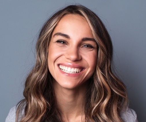 Woman sharing healthy smile after wisdom tooth extraction